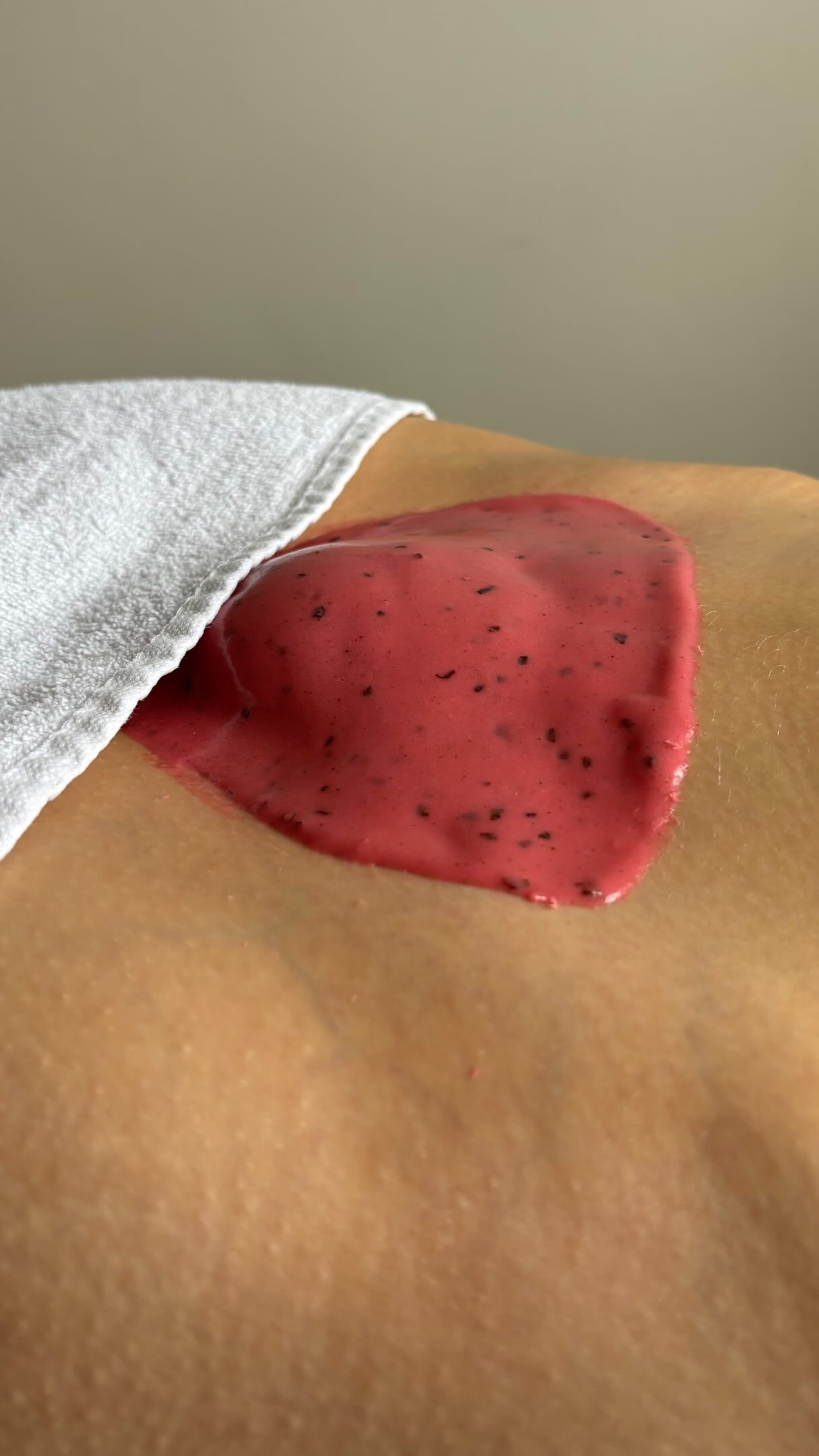 A set jelly mask being lifted off a freshly waxed Brazilian in one piece